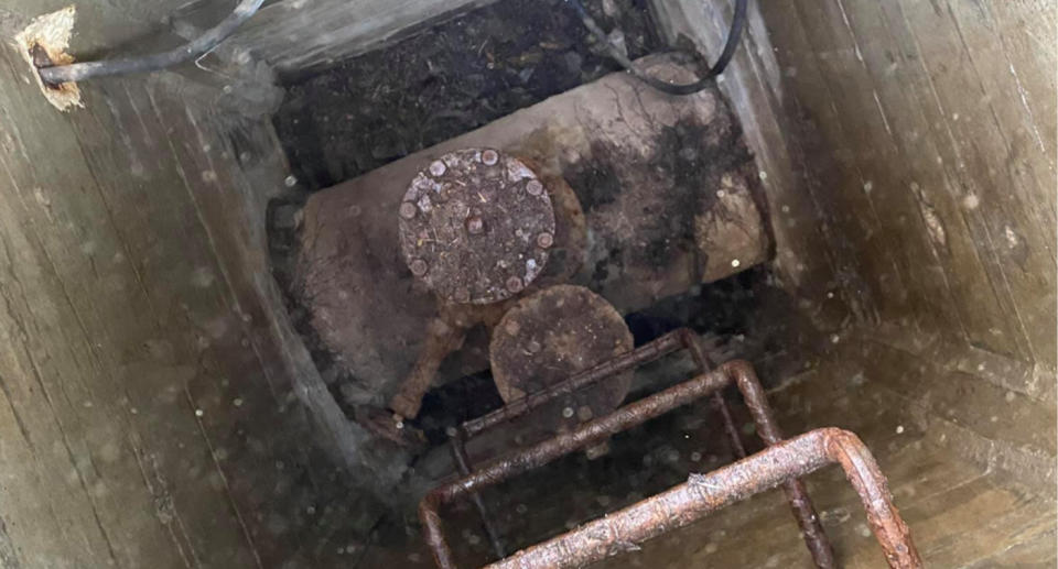 The manhole was covering a shaft with steps down to a large water main pipe. Source: Facebook
