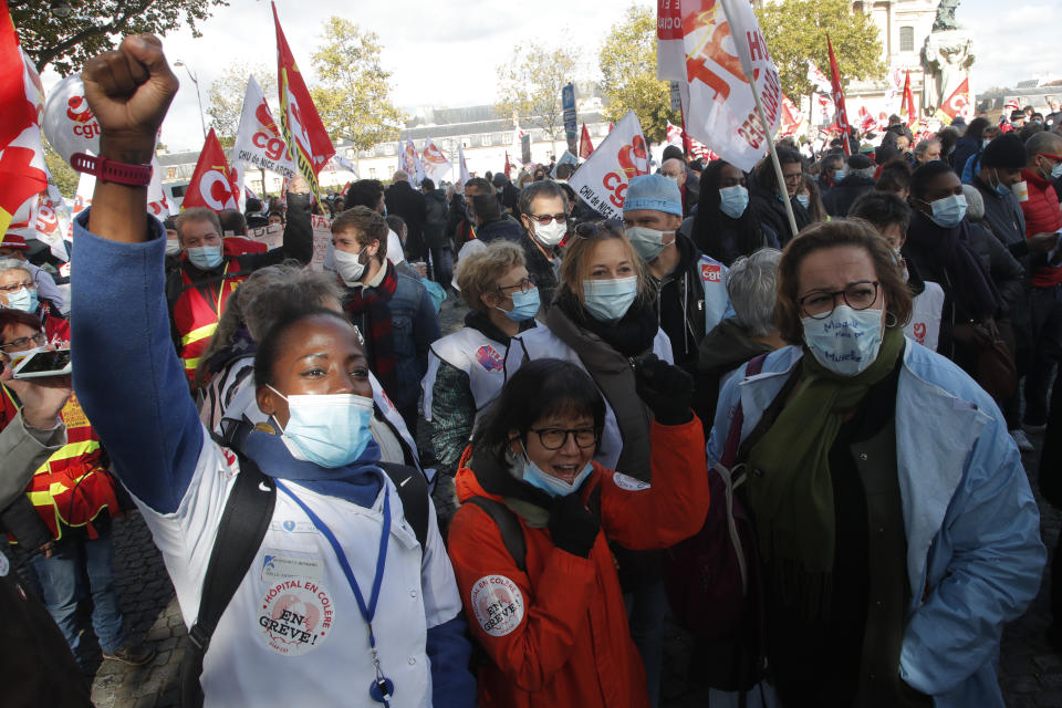 Medical workers demonstrate to demand better salaries and working conditions, Thursday, Oct. 15, 2020 in Paris. French President Emmanuel Macron has announced that millions of French citizens in several regions around the country, including in Paris, will have to respect a 9pm curfew from this Saturday until Dec. 1. It's a new measure aimed at curbing the resurgent coronavirus amid second wave. The measures will require citizens in certain regions where the coronavirus is circulating to be at home after 9pm. (AP Photo/Michel Euler)