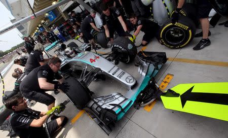 Mechanics of Mercedes Formula One practice a pit stop on the car of Lewis Hamilton of Britain during the third free practice of the Brazilian F1 Grand Prix in Sao Paulo, Brazil, November 14, 2015. REUTERS/Paulo Whitaker