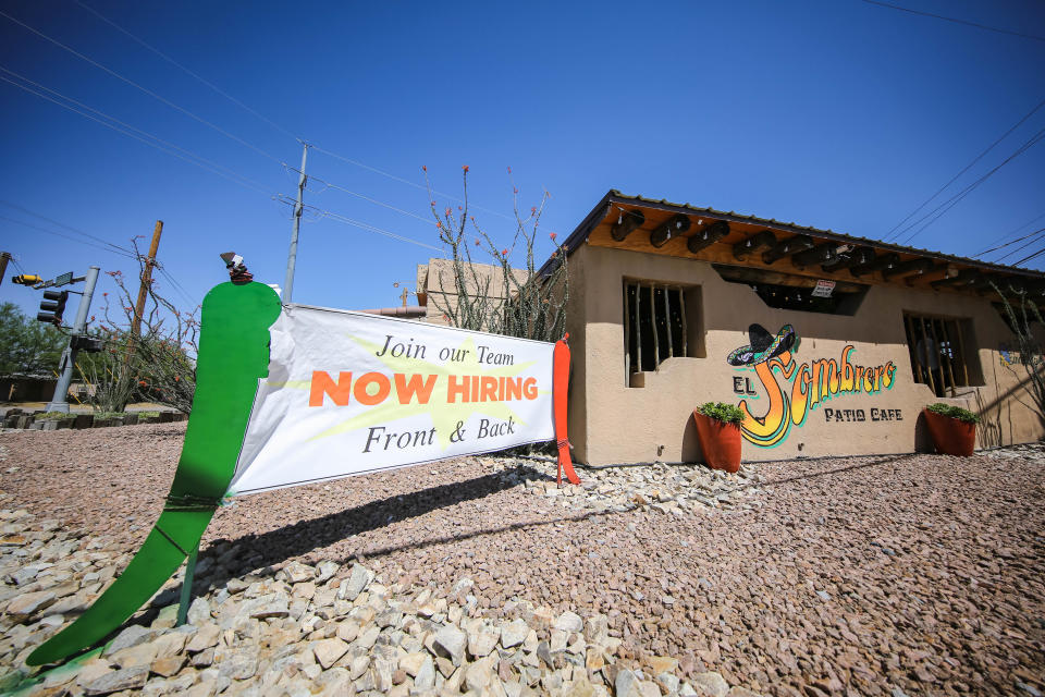 A sign announcing hiring at El Sombrero Patio Cafe sits next to the building on Tuesday, May 18, 2021.