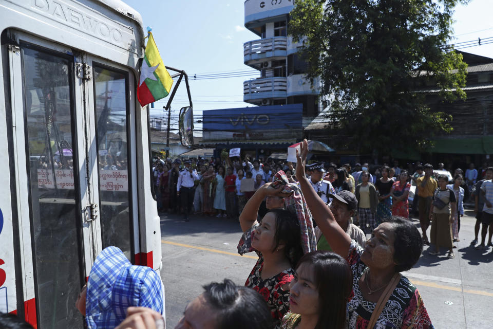 Family members and colleagues surround released prisoners on bus outside Insein Prison in Yangon, Myanmar, Thursday, Jan. 4, 2024. Myanmar’s military government on Thursday pardoned nearly 10,000 prisoners to mark the 76th anniversary of gaining independence from Britain, but it wasn’t immediately clear if any of those released included the thousands of political detainees jailed for opposing army rule. (AP Photo/Thein Zaw)