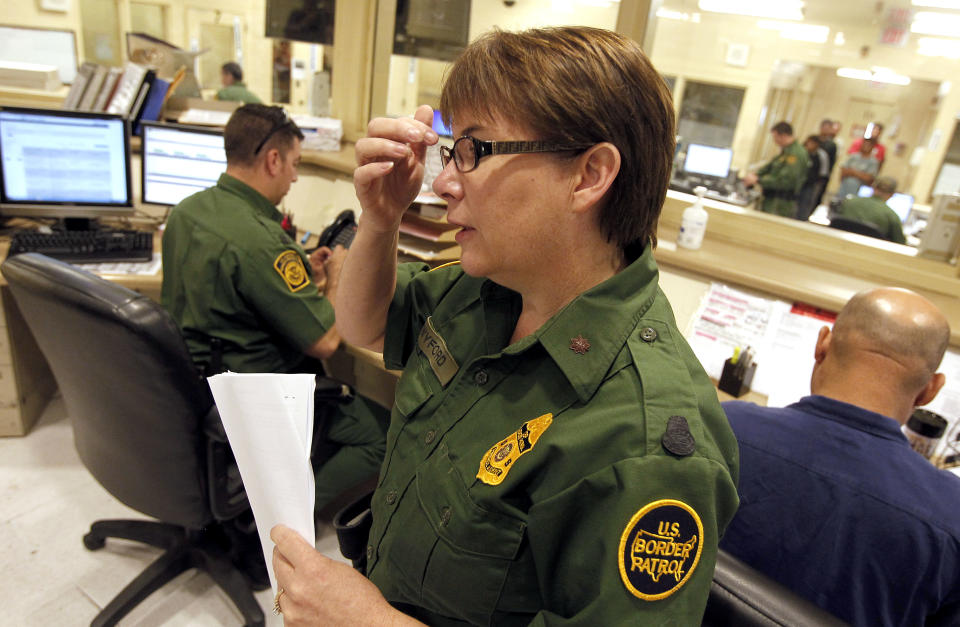 U.S. Border Patrol Tucson Sector Branch Chief Donna Twyford examines an illegal immigrant's file as they are processed at Tucson Sector U.S. Border Patrol Headquarters Thursday, Aug. 9, 2012, in Tucson, Ariz. The U.S. government has halted flights home for Mexicans caught entering the country illegally in the deadly summer heat of Arizona's deserts, a money-saving move that ends a seven-year experiment that cost taxpayers nearly $100 million.(AP Photo/Ross D. Franklin)