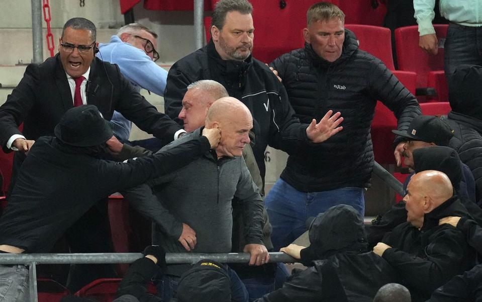 Trouble breaks out in the stands after the Europa Conference League semi-final match between AZ Alkmaar and West Ham - West Ham players leap into stands to defend families from ultra attack - ANP/AFP via Getty Images