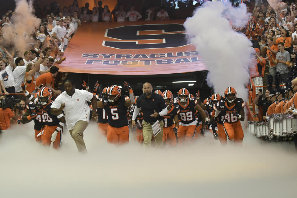 Syracuse team enters the Carrier Dome during the NCAA college football game Saturday, Sept. 14, 2019, in Syracuse, N.Y. (AP Photo/Steve Jacobs)