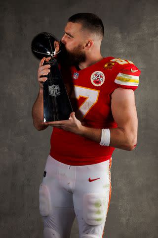 <p>Ryan Kang/Getty</p> Travis Kelce poses with the Vince Lombardi Trophy after 2024 Super Bowl win.