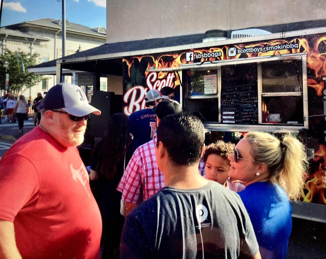 Food Truck Friday returns to downtown Perry on July 15. In this May 2021 Telegraph file photo, people chat in front of Scott Boys Smokin’ BBQ at a Food Truck Friday in downtown Perry. Scott Boys Smokin’s BBQ returns to the July 15 event.