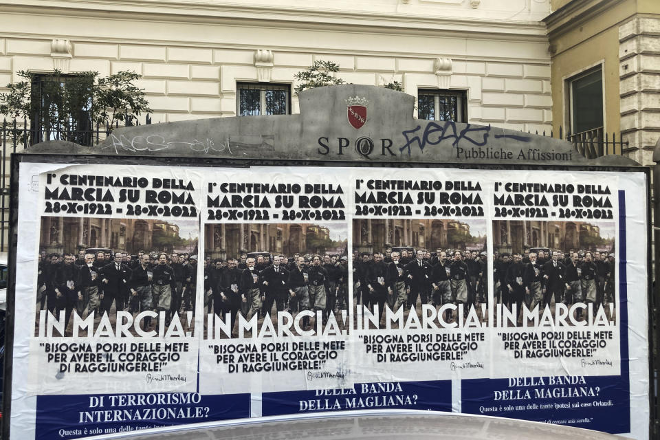 Posters commemorating the 100th anniversary of the March on Rome bearing a picture of Italian Fascist Dictator Benito Mussolini reading: "Marching!" with a quote by Mussolini "you have to set yourself goals to have the courage to reach them" are posted on the Rome's public billboard space, Thursday, Oct. 27, 2022. (AP Photo/Gregorio Borgia)