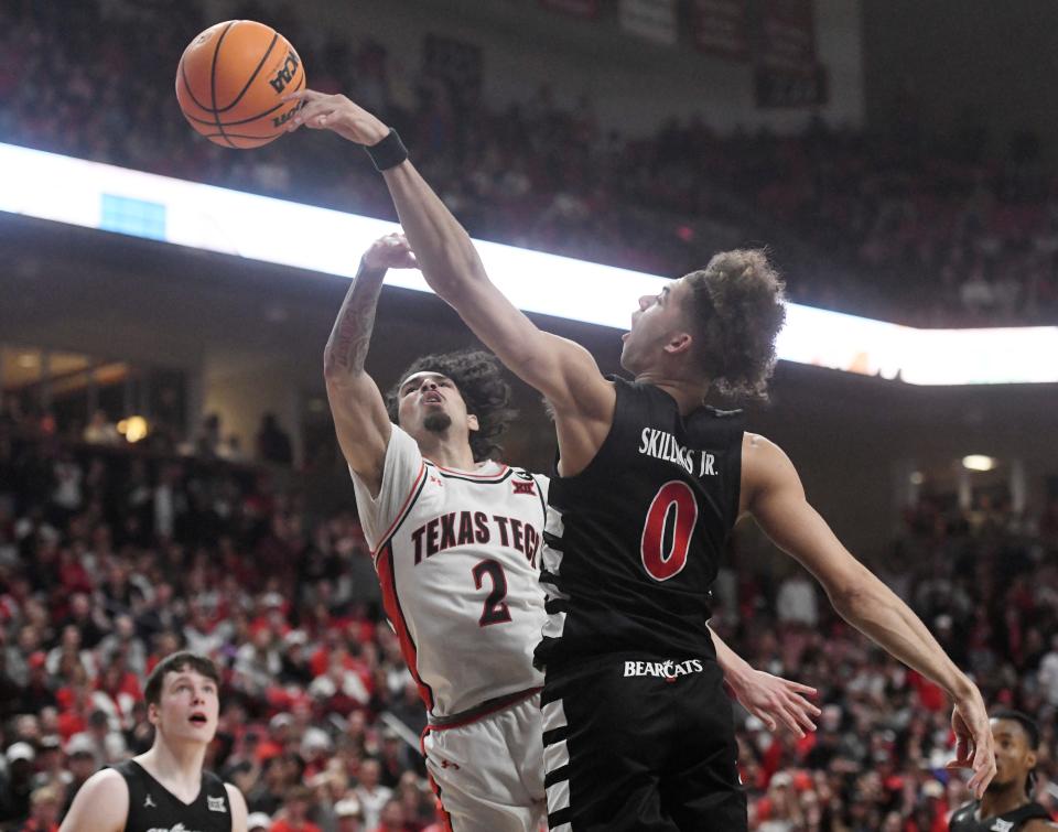 Cincinnati's guard Dan Skillings Jr. (0) blocks Texas Tech's guard Pop Isaacs' (2) shot during the Bearcats 75-72 win over the No. 15 Red Raiders.