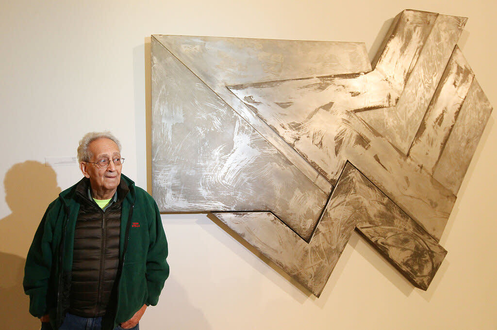 U.S. artist Frank Stella poses in front of one of his works at an exhibition devoted to him in Warsaw, Poland.