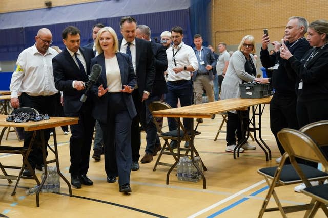 Former prime minister Liz Truss is surrounded by media as she departs after losing her Norfolk South West seat to the Labour Party, at Alive Lynnsport in King’s Lynn, Norfolk