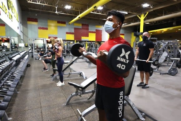 A masked man works out at Gold&#39;s Gym Islip on August 24, 2020 in Islip, New Yor