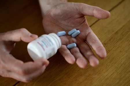 Will Nutland, who supports a drug-buying network and takes generic drugs himself to prevent HIV infection, shows off some of his generic drugs during an interview with Reuters at his home in central London, Britain November 3, 2016. REUTERS/Dylan Martinez