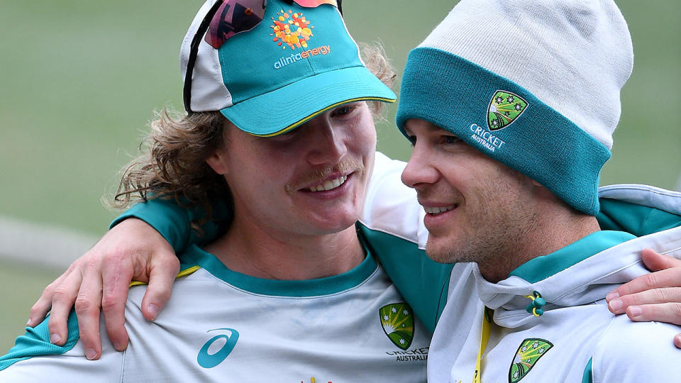 Australia's Will Pucovski and Tim Paine have a laugh at training ahead of the third Test at the SCG. (Photo by SAEED KHAN/AFP via Getty Images)