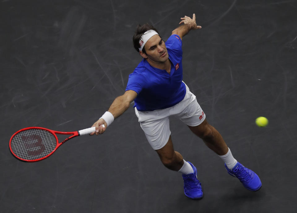 Team Europe's Roger Federer stretches for a ball hit by Team World's John Isner during a men's singles tennis match at the Laver Cup, Sunday, Sept. 23, 2018, in Chicago. (AP Photo/Jim Young)