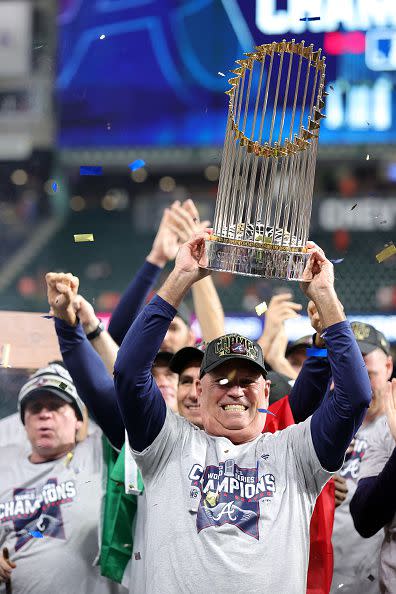 HOUSTON, TEXAS - NOVEMBER 02:  Manager Brian Snitker #43 of the Atlanta Braves hoists the commissioner's trophy following the team's 7-0 victory against the Houston Astros in Game Six to win the 2021 World Series at Minute Maid Park on November 02, 2021 in Houston, Texas. (Photo by Carmen Mandato/Getty Images)