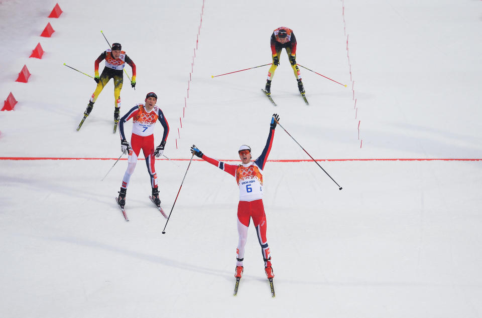 SOCHI, RUSSIA - FEBRUARY 18:  Joergen Graabak of Norway celebrates as he crosses the line to win the gold medal ahead of Magnus Hovdal Moan of Norway in the Nordic Combined Men's 10km Cross Country during day 11 of the Sochi 2014 Winter Olympics at RusSki Gorki Nordic Combined Skiing Stadium on February 18, 2014 in Sochi, Russia.  (Photo by Lars Baron/Getty Images)