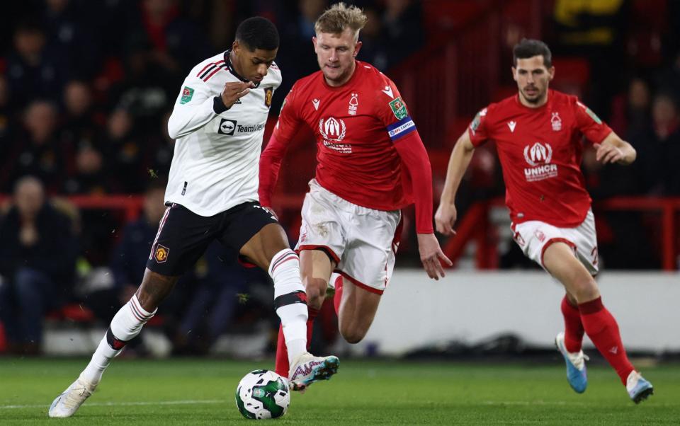 Manchester United's English striker Marcus Rashford (L) runs with the ball to score his team first goal during the English League Cup semi-final first-leg football match between Nottingham Forest and Manchester United, - DARREN STAPLES/AFP via Getty Images