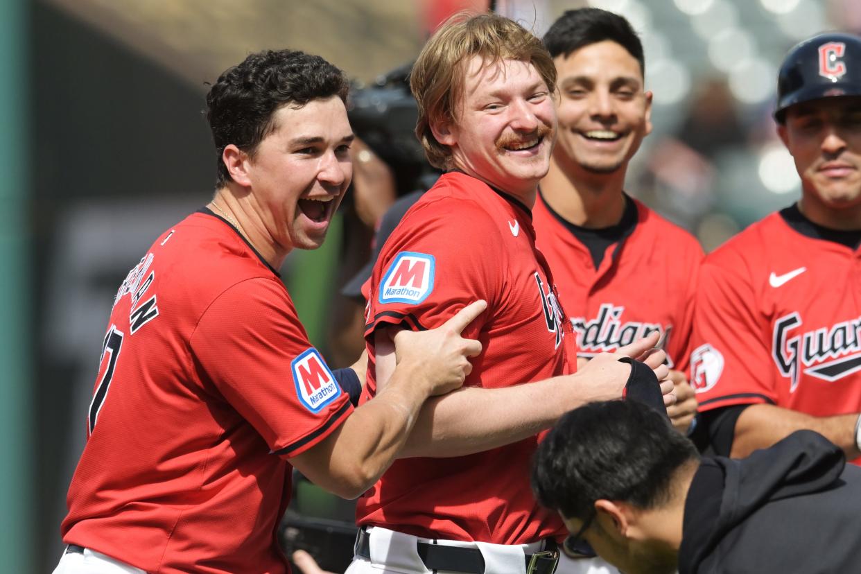 Cleveland Guardians' Will Brennan, left, and Kyle Manzardo, middle, celebrate after Brayan Rocchio (not pictured) hit a game-winning single in the 10th inning against the Detroit Tigers on Wednesday at Progressive Field.