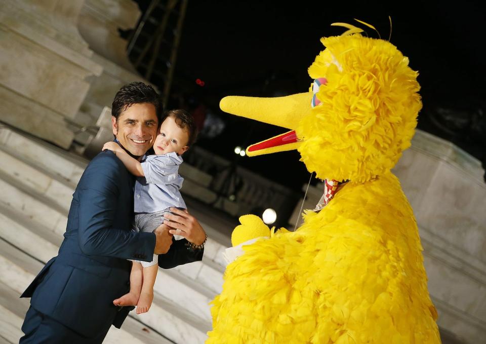 <p>John Stamos introduces his son Billy Stamos to Sesame Street's Big Bird during an event in Washington D.C. in 2019. </p>