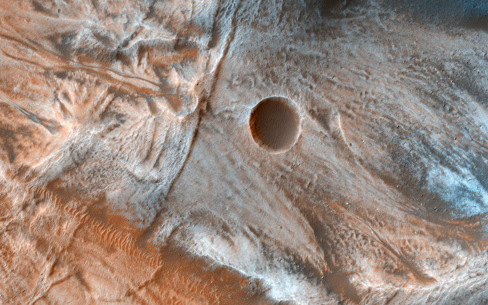 <p>A view of the surface of Mars released by NASA on March 7, 2017, shows viscous, lobate flow features commonly found at the bases of slopes in the mid-latitudes of Mars, and are often associated with gullies. These are bound by ridges that resemble terrestrial moraines, suggesting that these deposits are ice-rich, or may have been ice-rich in the past. (Photo: NASA/JPL-Caltech/Univ. of Arizona/Reuters) </p>
