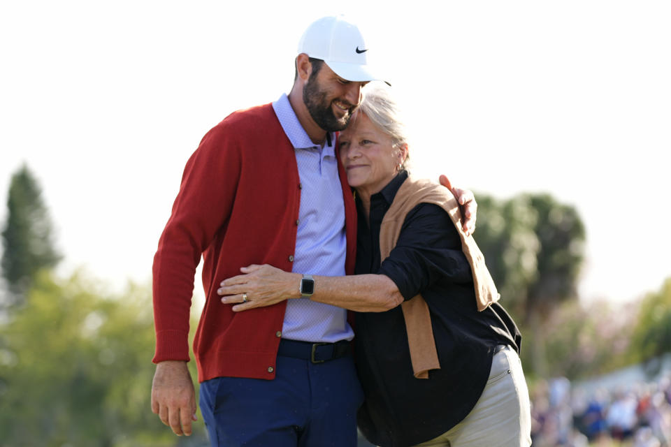 Scottie Scheffler, left, gets a hug from Amy Palmer Saunders, daughter of Arnold Palmer after he won the Arnold Palmer Invitational golf tournament Sunday, March 10, 2024, in Orlando, Fla. (AP Photo/John Raoux)