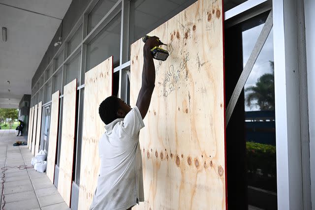 <p>RICARDO MAKYN/AFP via Getty</p> Windows being boarded up in Jamaica on July 3