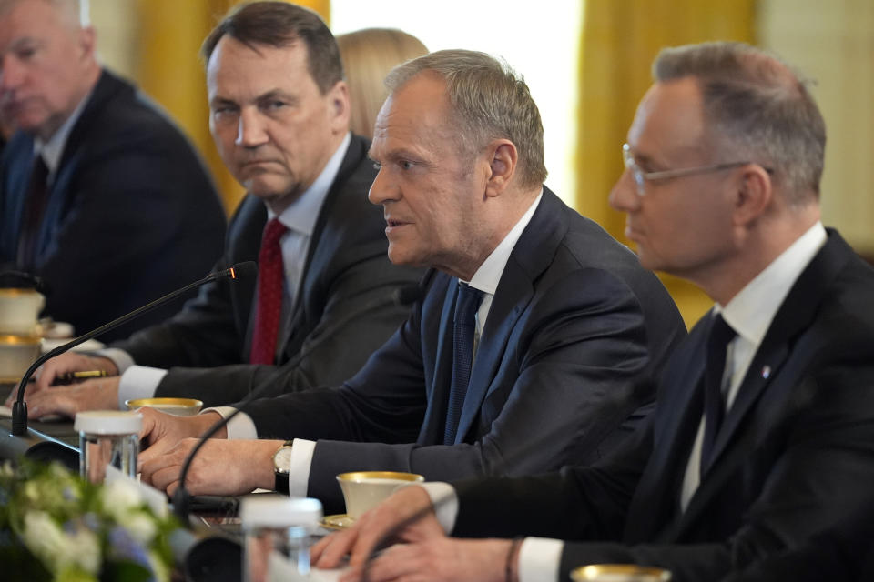 Polish President Andrzej Duda, right, listens as Polish Prime Minister Donald Tusk, second from right, speaks during a meeting with President Joe Biden in the East Room of the White House, Tuesday, March 12, 2024, in Washington. (AP Photo/Andrew Harnik)