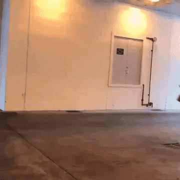 A lone man sprinting through a large garage