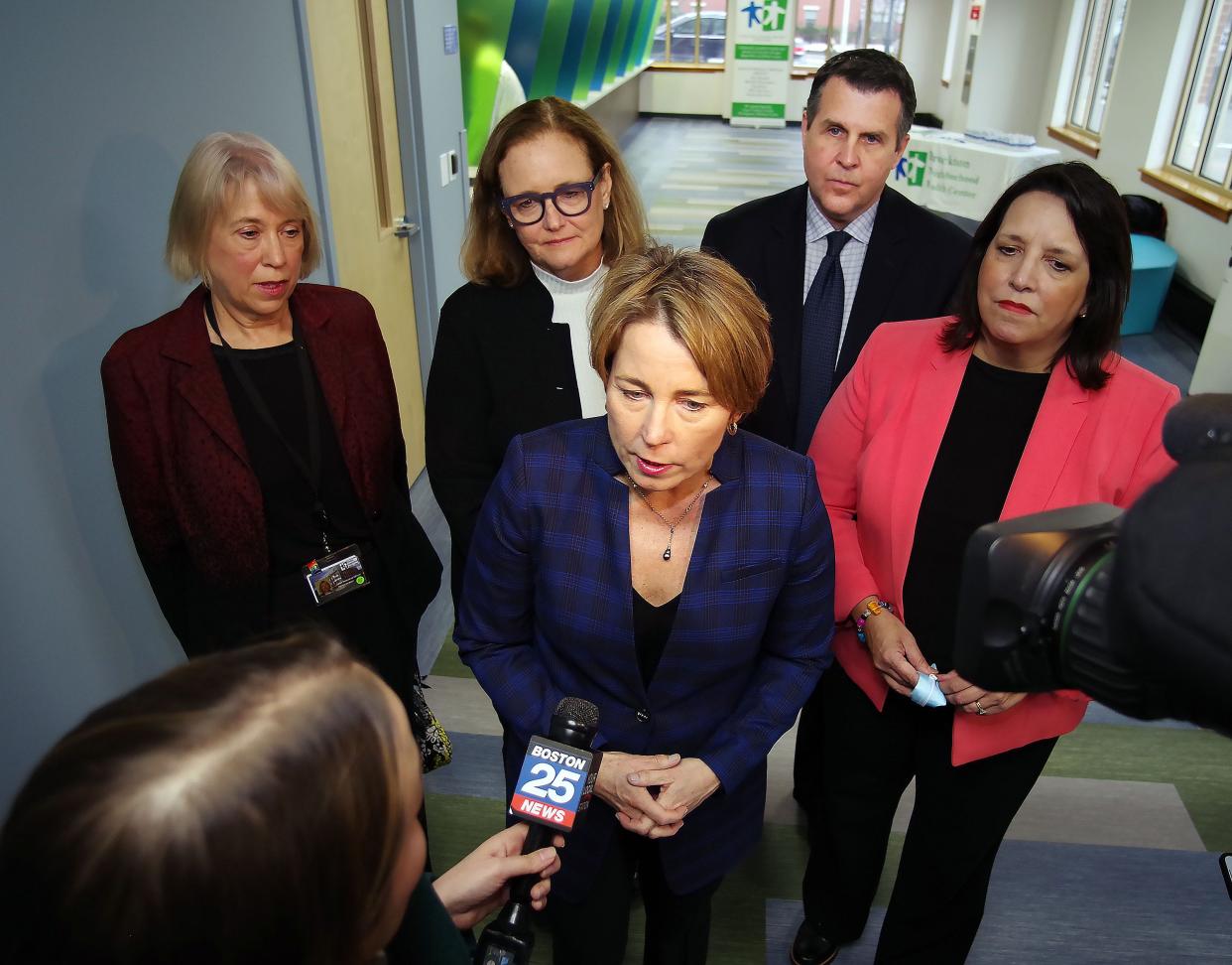 Brockton Neighborhood Health Center CEO Sue Joss, Mass. Health & Human Services Secretary Kate Walsh, Mayor Robert Sullivan, and Lt. Governor Kim Driscoll, stand behind Gov. Maura Healey on a visit to the health center on Thursday, March 2, 2023.