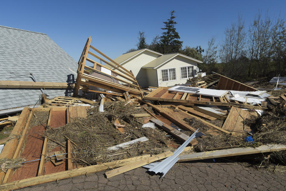 Debris from destroyed cottages litters the ground at a cottage development in the French River area of Prince Edward Island on Sunday, Sept. 25, 2022. Hundreds of thousands of people in Atlantic Canada remained without power Sunday after former Hurricane Fiona washed away houses, stripped off roofs and blocked roads across the country’s Atlantic provinces. (Brian McInnis/The Canadian Press via AP)