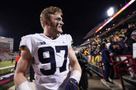 FILE - Michigan defensive end Aidan Hutchinson looks on after an NCAA college football game against Maryland, Saturday, Nov. 20, 2021, in College Park, Md. Michigan won 59-18. Michigan coach Jim Harbaugh said star defensive end Aidan Hutchinson should be strongly considered for the Heisman Trophy after he had three sacks, setting a single-season record for college football team, in a win over Ohio State that put the Wolverines in the Big Ten championship game and national title race. (AP Photo/Julio Cortez, File)