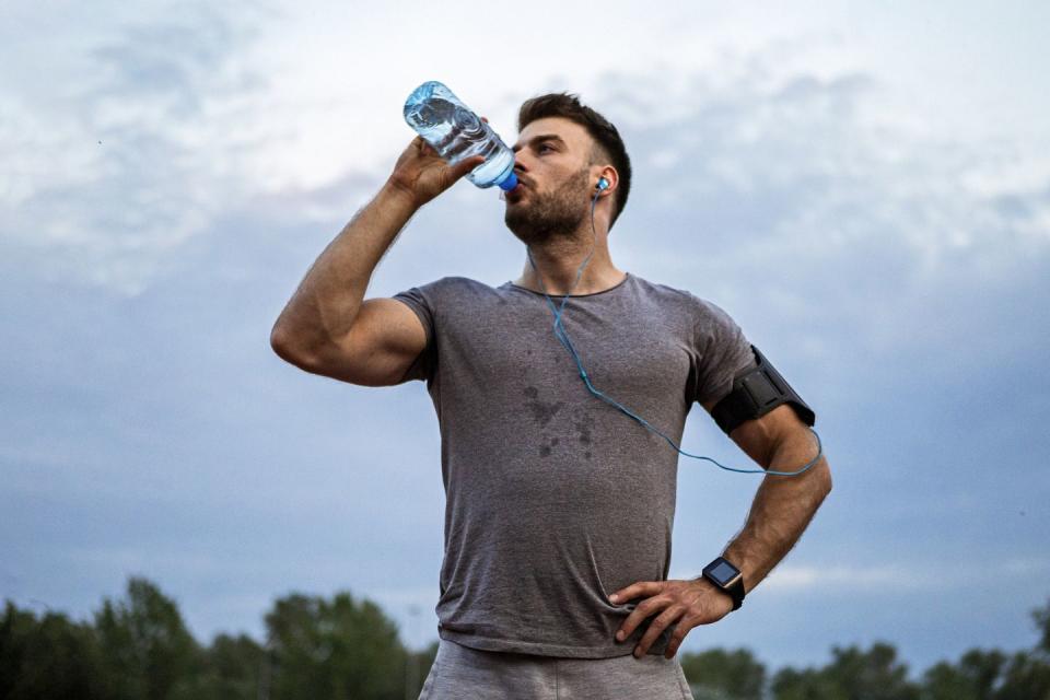young man running hydrating