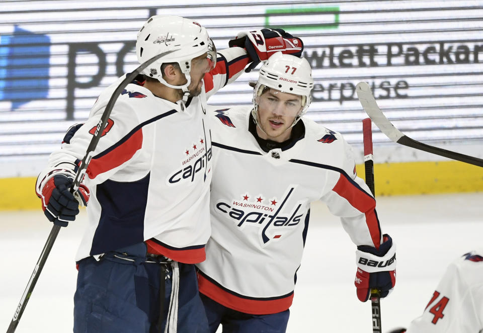 Washington Capitals' Alex Ovechkin (8), of Russia, and T.J. Oshie (77) celebrate a power play goal by Ovechkin against the Minnesota Wild during the first period of an NHL hockey game Sunday, March 1, 2020, in St. Paul, Minn. (AP Photo/Hannah Foslien)