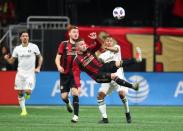 Dec 8, 2018; Atlanta, GA, USA; Atlanta United defender Greg Garza (front) kicks the ball against Portland Timbers forward Andy Polo (right) in the second half in the 2018 MLS Cup championship game at Mercedes-Benz Stadium. Mark J. Rebilas-USA TODAY Sports