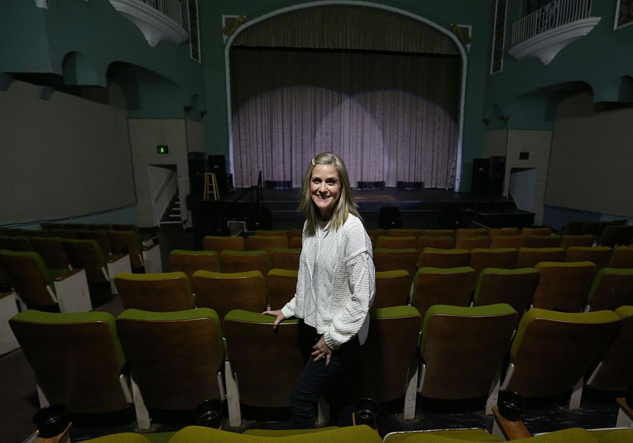 Melissa Sly, president of the Camelot Theater Foundation, poses during a tour at the historic theater in downtown Nevada, Iowa.