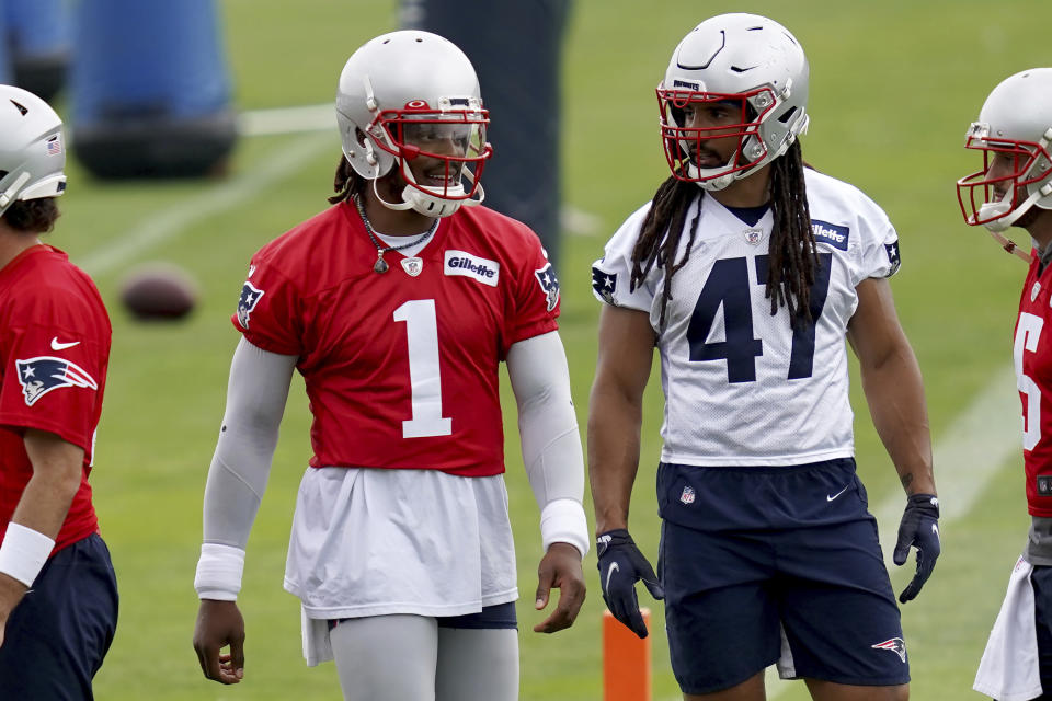 New England Patriots quarterback Cam Newton (1) talks with Jakob Johnson (47) during NFL football practice in Foxborough, Mass., Friday, June 4, 2021. (AP Photo/Mary Schwalm)