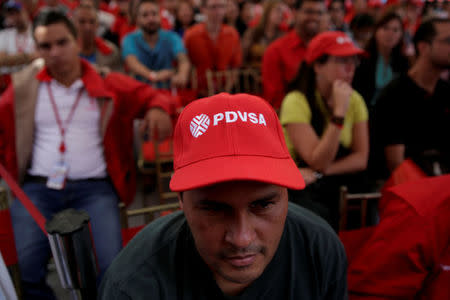 FILE PHOTO: A man wears a cap with the logo of PDVSA as he attends the swear-in ceremony of the new board of directors of Venezuelan state oil company PDVSA in Caracas, Venezuela January 31, 2017. REUTERS/Marco Bello/File Photo