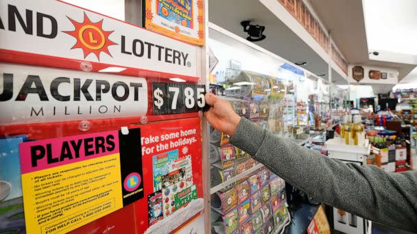 PHOTO: A clerk at Broad Street Liquors updates the Mega Millions jackpot at the store's lottery counter, Tuesday, Jan. 3, 2023, in Timonium, Md. (Julio Cortez/AP)