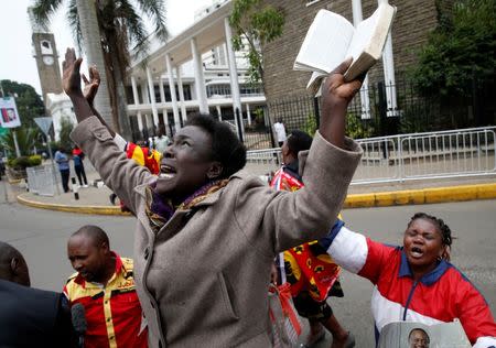 Jubilee Party supporters cheer after Kenya's Supreme Court upheld the re-election of President Uhuru Kenyatta in last month's repeat presidential vote, in Nairobi, Kenya November 20, 2017. REUTERS/Baz Ratner