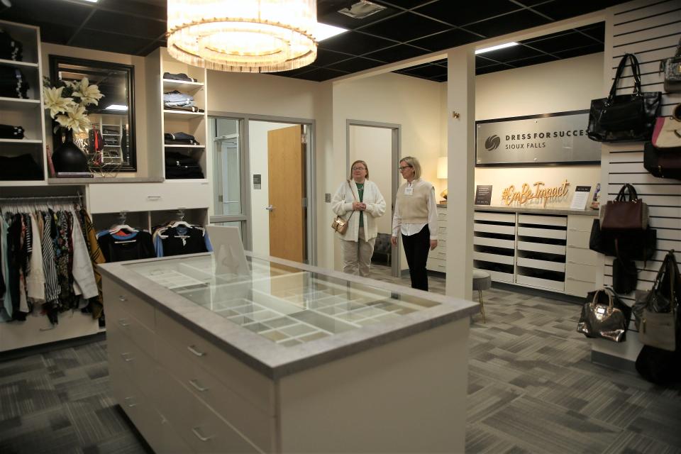 Embe volunteer Jeannie Blackman shows Theresa Lucus, who works with partner agency Sioux Falls Housing, around the newly renovated Dress for Success and Embe programming space. The Dress for Success closet features two dressing rooms and several donated items ranging from jewelry, blouses, pants, dresses and purses.