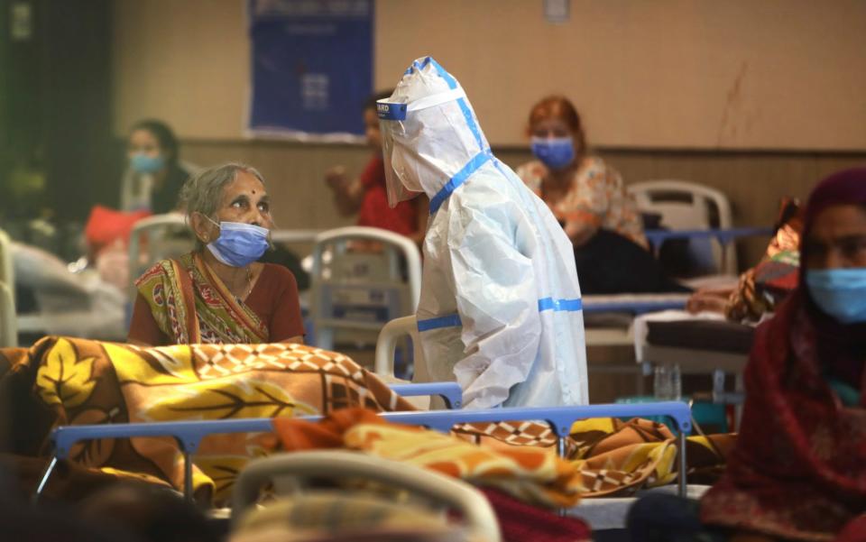 A health worker talks to a woman in a quarantine centre for Covid patients in New Delhi - AP