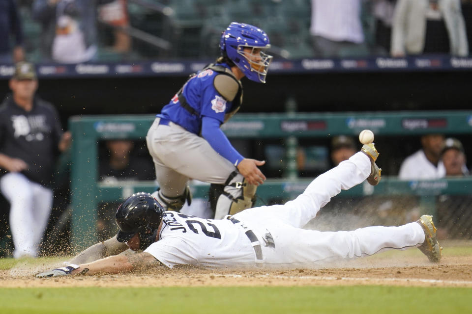 Detroit Tigers' JaCoby Jones slides safely into home plate to score on a Harold Castro single as Chicago Cubs catcher Tony Wolters (11) waits for the throw in the 10th inning of a baseball game in Detroit, Saturday, May 15, 2021. Detroit won 9-8. (AP Photo/Paul Sancya)