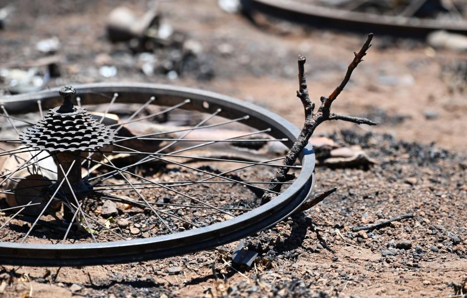 A bike wheel sits in a burned field of Lahaina, Hawaii, on Thursday, Aug. 17, 2023. Response to the fire continues to come in from neighboring islands and the mainland. | Scott G Winterton, Deseret News