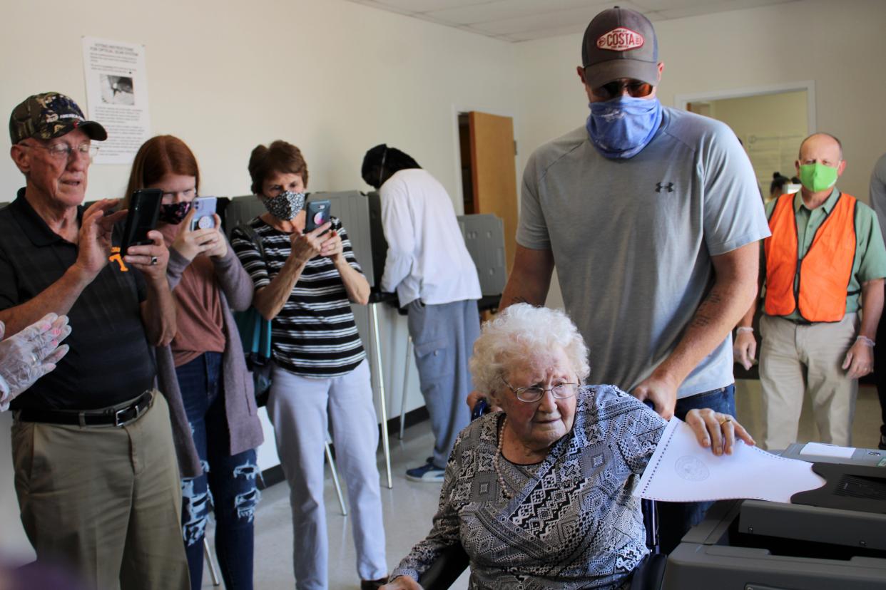 Centenarian Mabel Dorothy Duty Cook of Chesterfield casts her ballot at the Registrar's Office in Chesterfield on Oct. 15, 2020. Family members from left to right capture the moment,  Sherman, Alexa, Linda, and Curtis Litton.