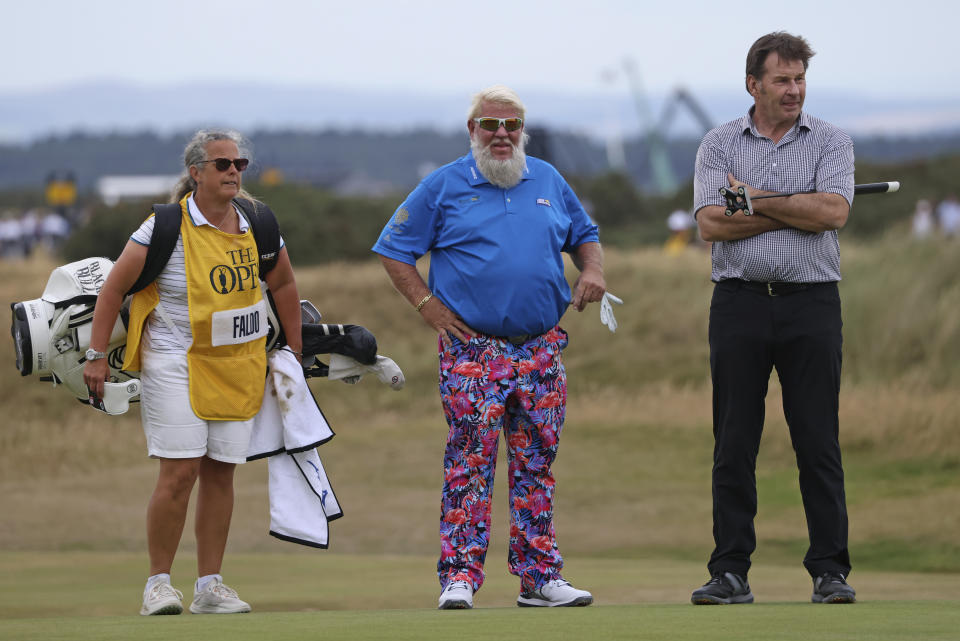 John Daly of the United States, center, and England's Nick Faldo stand on the 17th green during a 'Champions round' as preparations continue for the British Open golf championship on the Old Course at St. Andrews, Scotland, Monday July 11, 2022. The Open Championship returns to the home of golf on July 14-17, 2022, to celebrate the 150th edition of the sport's oldest championship, which dates to 1860 and was first played at St. Andrews in 1873. (AP Photo/Peter Morrison)