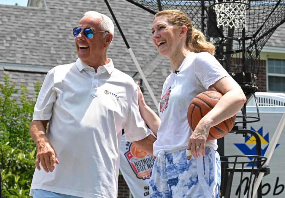 Former North Carolina head basketball coach Roy Williams, left, jokes with former North Carolina State women’s basketball player and current college basketball analyst Debbie Antonelli, right, during her 24 Hours of Nothing But Net event to help Special Olympics on Saturday, May 13, 2023. Williams stopped by Antonelli’s home to offer support. Antonelli shoots and makes 100 free throws every hour for 24 hours.