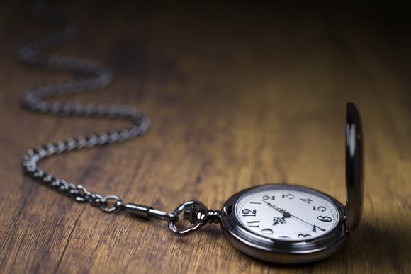 Pocket watch opened on a table.