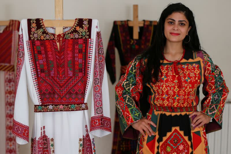 A model presents traditional Palestinian dresses at Al Hanouneh society for popular culture in Amman