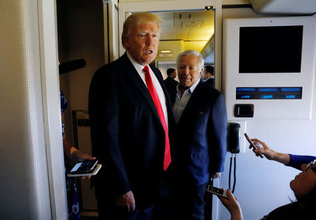 U.S. President Donald Trump speaks to reporters with New England Patriots owner Robert Kraft at his side aboard Air Force One as he departs West Palm Beach, Florida, U.S., to return to Washington March 19, 2017. REUTERS/Kevin Lamarque
