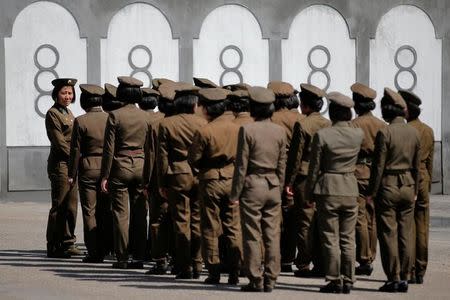 Uniformed women stand outside a subway station in central Pyongyang, North Korea May 7, 2016. REUTERS/Damir Sagolj